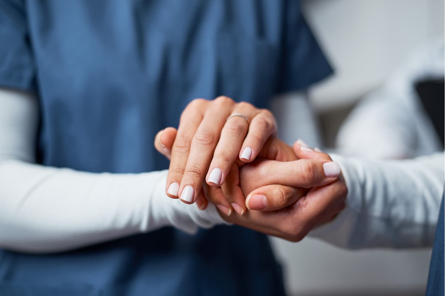 A clinician holding a patient’s hand
